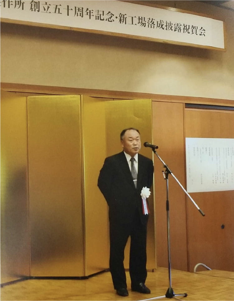 演壇上で挨拶する森川社長